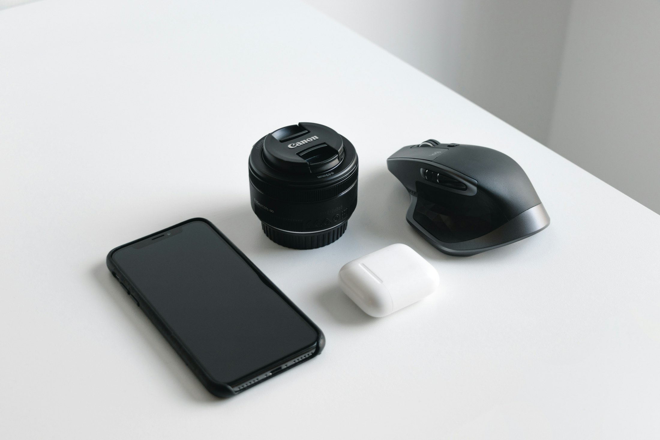 Consumer electronics including smartphone, camera lens, and wireless mouse